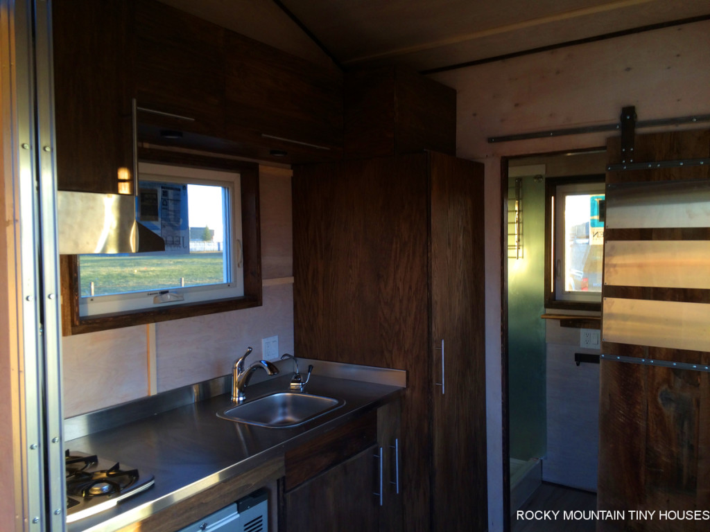 curved roof tiny house kitchen